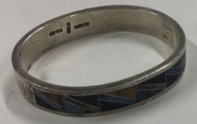 A heavy quality silver and stone bangle. Approx. 59 grams