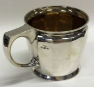 A silver christening mug with reeded decoration.