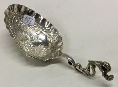 A 19th Century Dutch caddy spoon with embossed decoration.