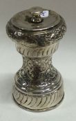 A late Victorian chased silver pepper grinder. By Walker and Hall.