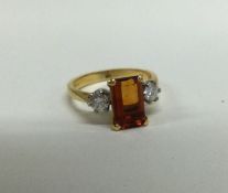 A good citrine (approx. 2.7 carats) and diamond (0.2 carats each) three stone ring in 18 carat gold.