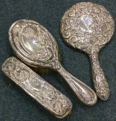 Two chased silver hairbrushes etc.Est. £20 - £30.