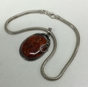 A large silver and stone set pendant on snake link chain. Approx. 65 grams.