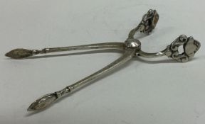 GEORG JENSEN: A good pair of silver sugar tongs of typical form.