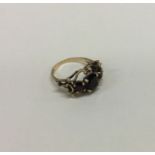 A 9 carat three stone ring in claw mount. Approx. 4 grams.