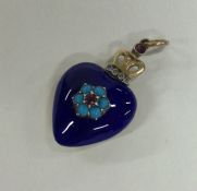 An attractive diamond and blue enamel heart shaped pendant with loop top.