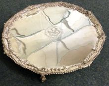 An 18th Century George III salver with coat of arms and chased border.