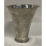 An early 18th Century Continental silver beaker with engraved floral design.