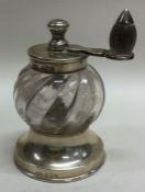 A silver mounted glass pepper grinder with fluted decoration.