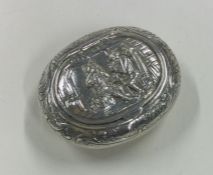 A chased silver box embossed with a tavern scene. Approx. 46 grams.