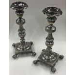 A fine pair of 18th Century silver cast candlesticks with claw feet.