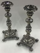 A fine pair of 18th Century silver cast candlesticks with claw feet.
