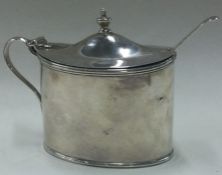 An 18th Century George III silver mustard pot with spoon. London 1798.