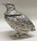 A heavy cast Victorian silver inkwell in the form of a bird.