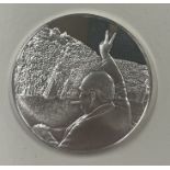 A silver coin commemorating VE Day 8th May 1945 depicting Winston Churchill.