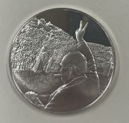 A silver coin commemorating VE Day 8th May 1945 depicting Winston Churchill.