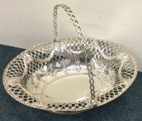 A large cast Georgian silver swing handled basket