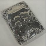 A chased silver card case embossed with cherubs. Birmingham 1903.