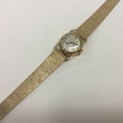 OMEGA: A lady's 9 carat wristwatch on mesh strap. Approx. 24 grams.