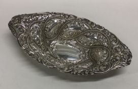 An attractive oval bonbon dish embossed with flowers