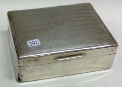 A heavy silver cigarette box with hinged lid.