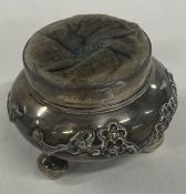 A Chinese export silver chased pin cushion. Circa 1880. By Luen Hing.