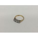 A good 18 carat gold and diamond mounted three stone ring in claw setting.
