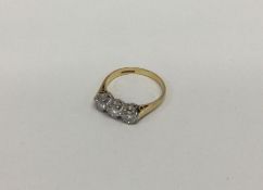 A good 18 carat gold and diamond mounted three stone ring in claw setting.