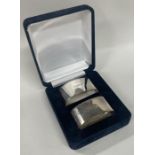 A pair of cased silver napkin rings. London 1996. By Richard Comyns.
