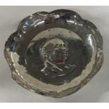 A solid silver dish depicting Mr Pickwick. With original registration number.