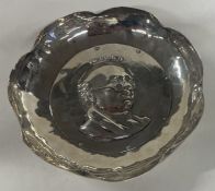 A solid silver dish depicting Mr Pickwick. With original registration number.