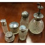 A large collection of silver mounted scent bottles. Est. £10 - £20.