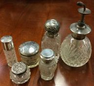 A large collection of silver mounted scent bottles. Est. £10 - £20.