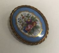 An attractive Victorian porcelain brooch of oval form.