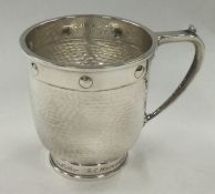 CHESTER: A Glastonbury silver mug of hammered design. 1923. By Barker Brothers.