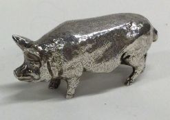 A cast silver figure of a pig bearing import marks