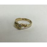 A 14 carat gold diamond four stone ring. Approx. 2 grams