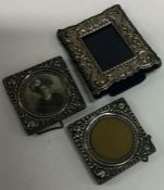 Three chased silver miniature picture frames. Est. £20 - £30.