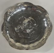 A solid silver dish depicting Charles Dickens character 'Mrs Gamp'.