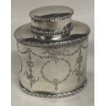 CHESTER: A decorative silver tea caddy with swag decoration. 1909.