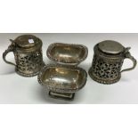 A pair of silver plated mustard pots etc. Est. £10 - £20.