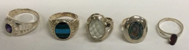 A collection of stone set and silver rings.
