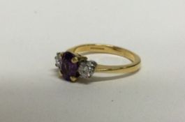 A fine quality amethyst (approx. 1.3 carats),and diamond (approx. 0.2 carats), three stone ring.