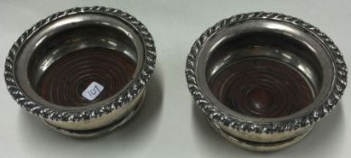 A pair of silver and wooden bottle coasters. Birmingham 1911. Approx. 169 grams