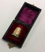 A boxed heavy gold thimble with turquoise decoration. Approx. 6 grams
