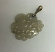 An unusual hard stone pendant of Chinese design with loop top.