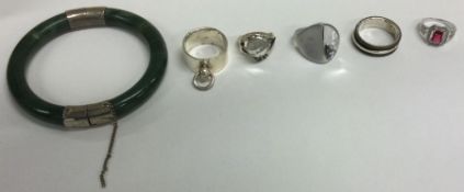 A collection of silver mounted rings together with a bangle.