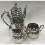 A three piece Danish silver coffee set in the style of Georg Jensen.