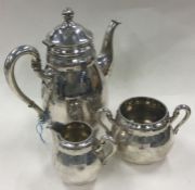 A three piece Danish silver coffee set in the style of Georg Jensen.