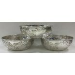 A good set of three chased silver bowls embossed with flowers. Sheffield 1916.